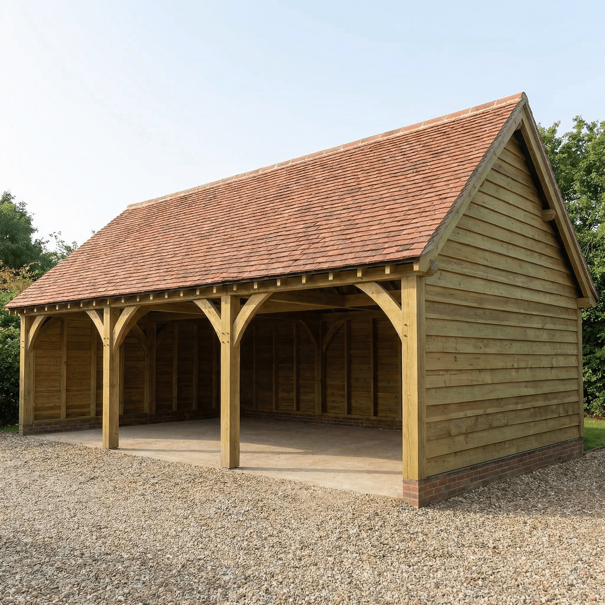 A hand-crafted 3-bay timber-framed garage with an open front and a red-tiled pitched roof.