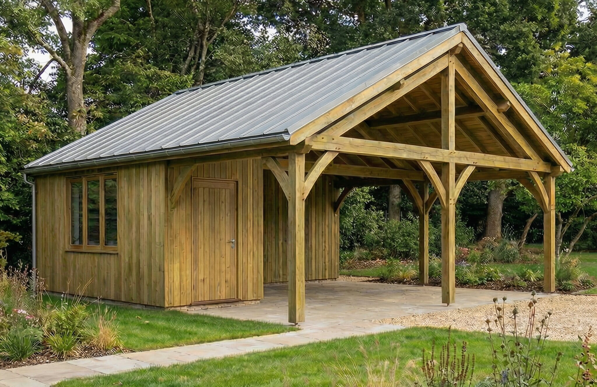 A timber-framed building featuring an open-sided double carport and an attached enclosed workshop with a metal roof and wooden door.